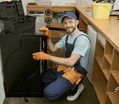 joyful-young-man-fixing-fridge-in-kitchen.jpg joyful-young-man-fixing-fridge-in-kitchen.jpg