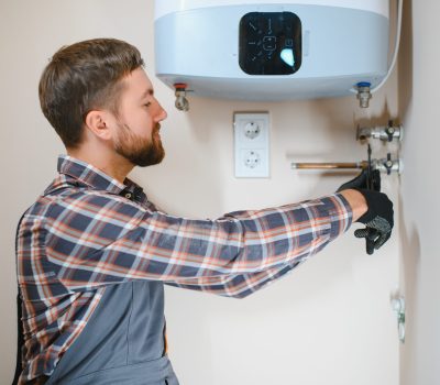 Professional plumber checking a boiler and pipes, boiler service concept Professional plumber checking a boiler and pipes, boiler service concept.